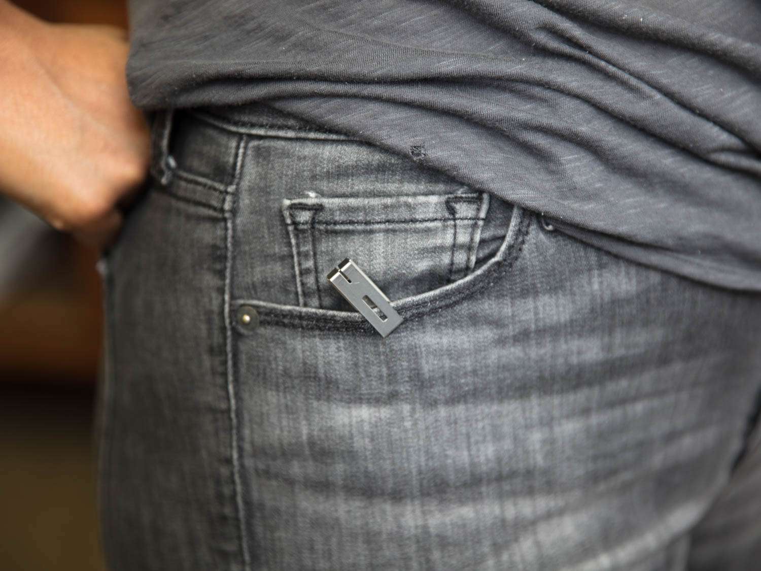 A utility knife clipped to a jeans pocket
