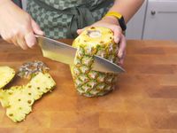 peeling the skin off a pineapple with the Misen chef knife