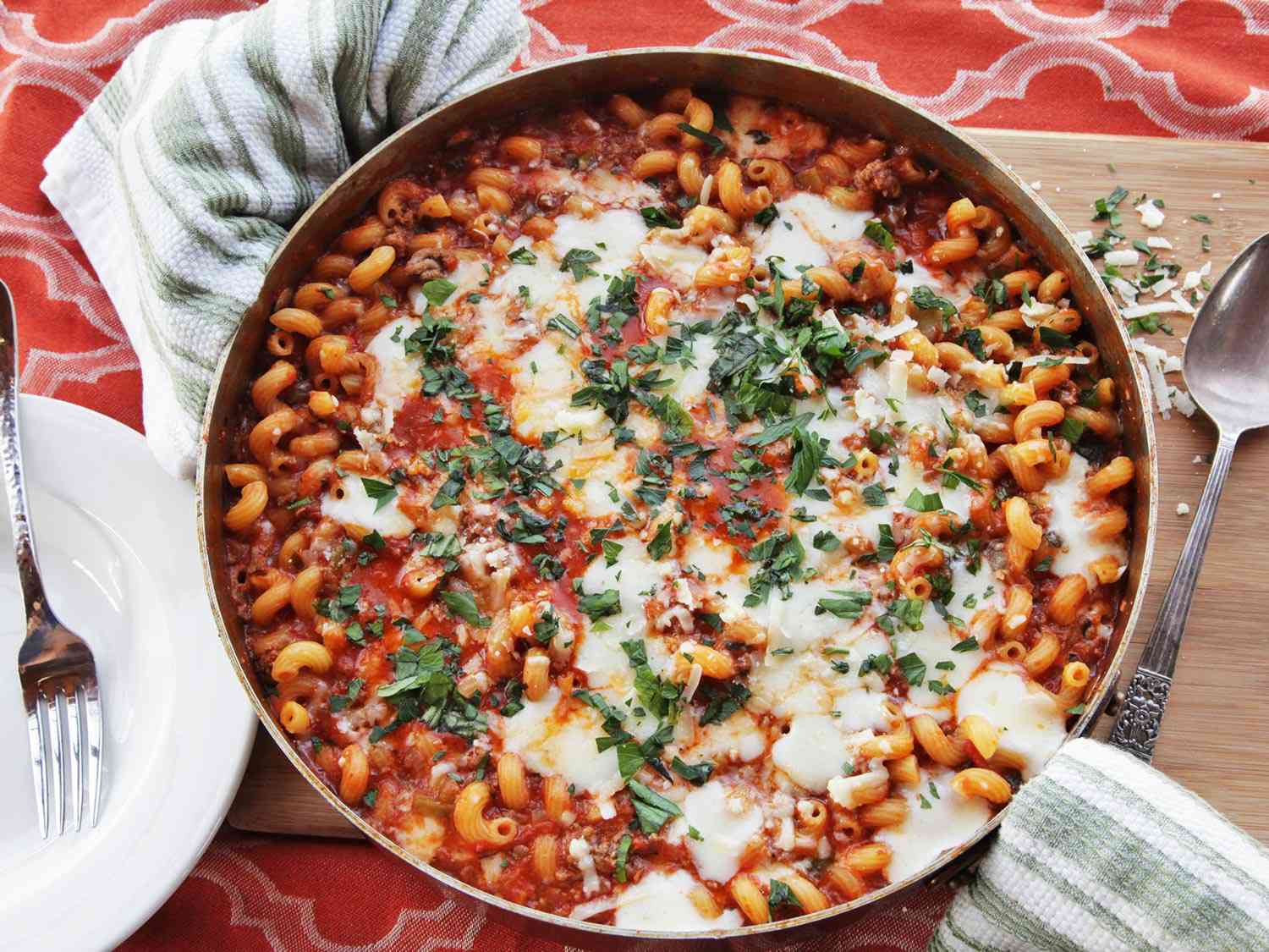 Overhead shot of the finished casserole. Melted cheese dots the surface and chopped parsley has been sprinkled on top.