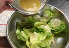 Author dresses little gem lettuce leaves with a simple vinaigrette.