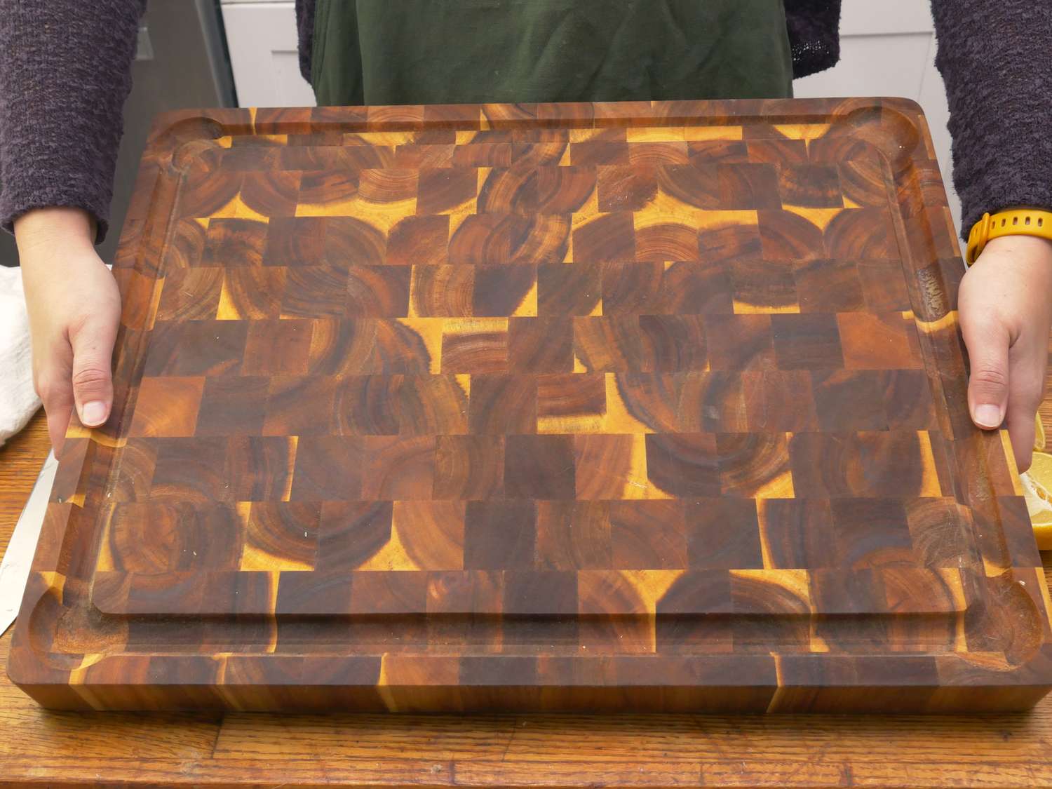 a person lifting the Yes4All wooden cutting board