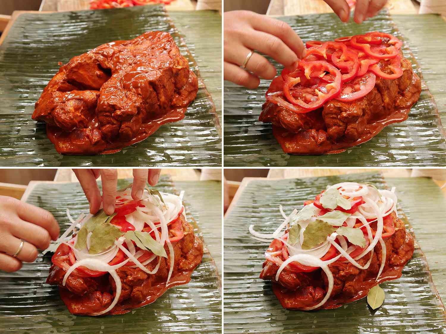 Topping raw pork shoulder on a banana leaf with bell peppers, onions, and bay leaves 