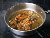 seared chicken with lemon pan sauce in a saute pan