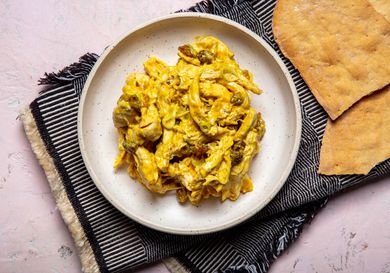 overhead shot of curry chicken salad on a beige plate