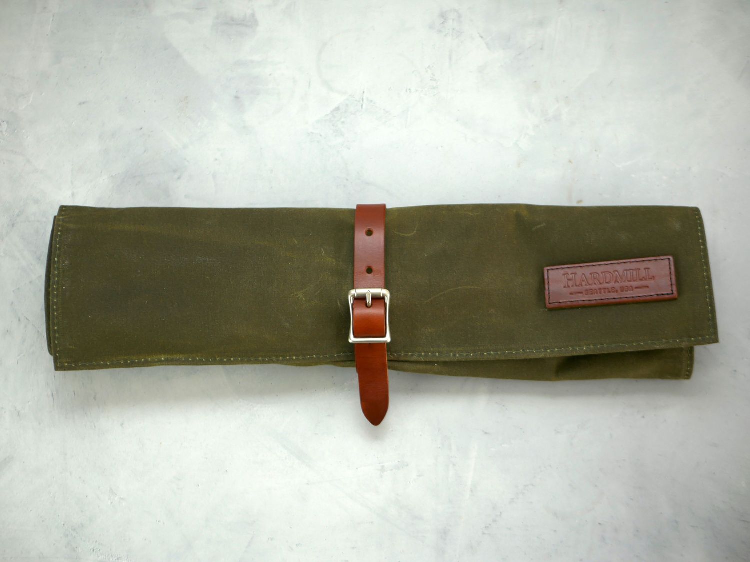 Hardmill knife roll on a gray surface