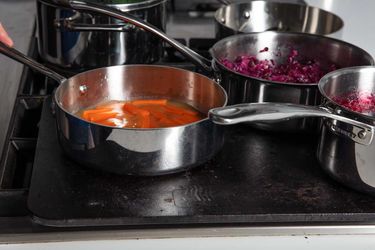 Side view of saucepans on a baking steel.
