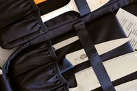 Knives stored in a black knife roll with some handles and blades partially visible