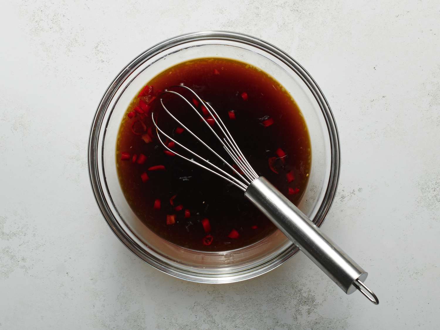 Dipping sauce mixed in a small glass bowl