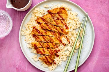 Overhead view of air fryer chicken katsu, served over rice.