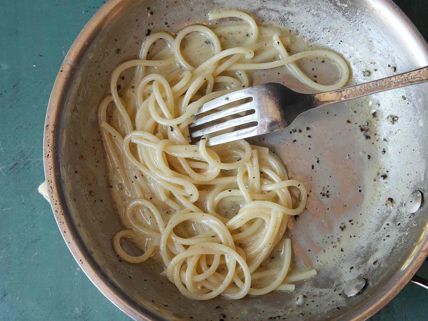 Cacio e pepe shown with a broken sauce.