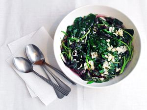 A bowl of spinach and red shen choy in garlicky broth.