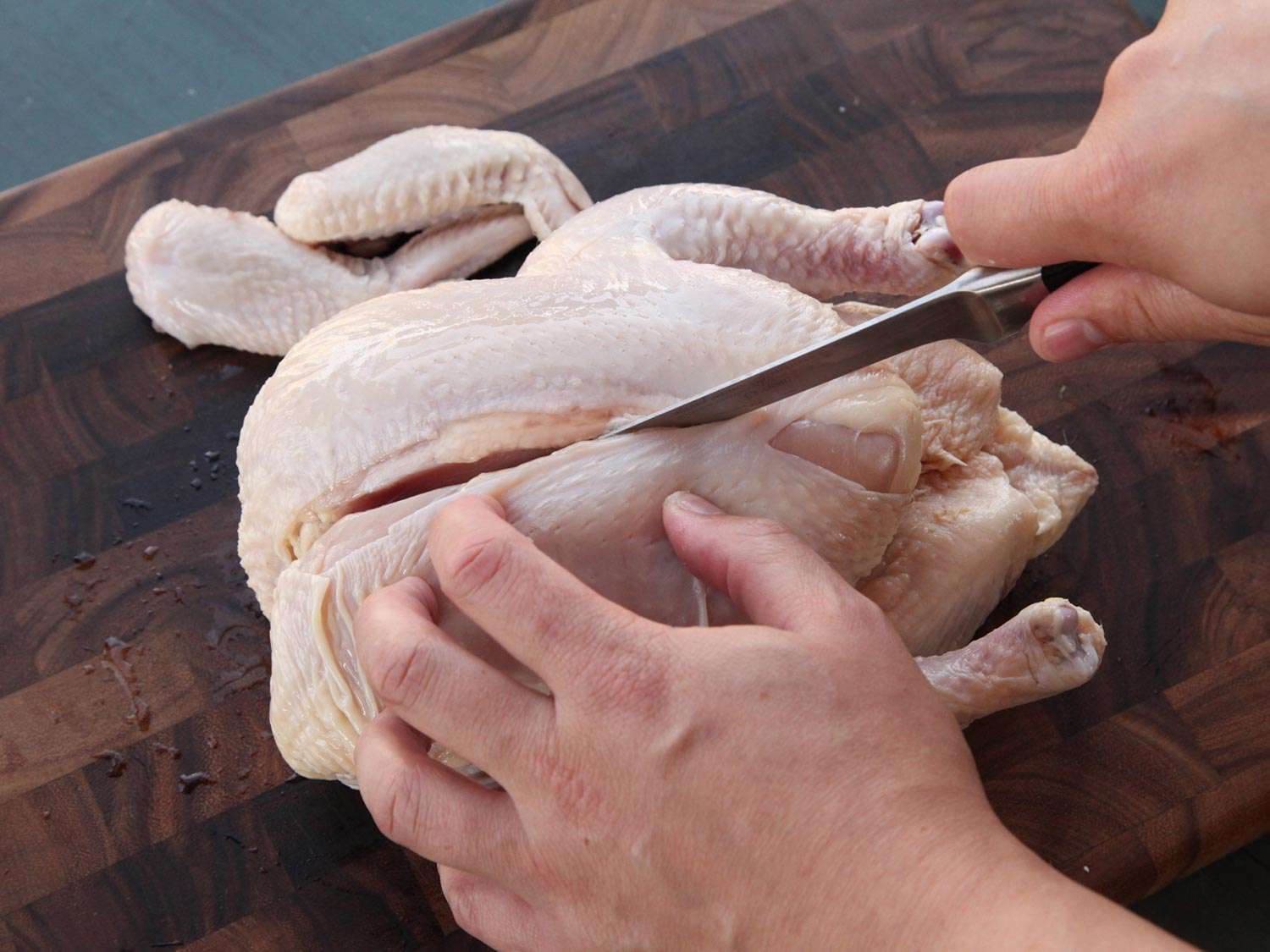 A boning knife inserted into a chicken along the breast bone, to remove the chicken breasts.
