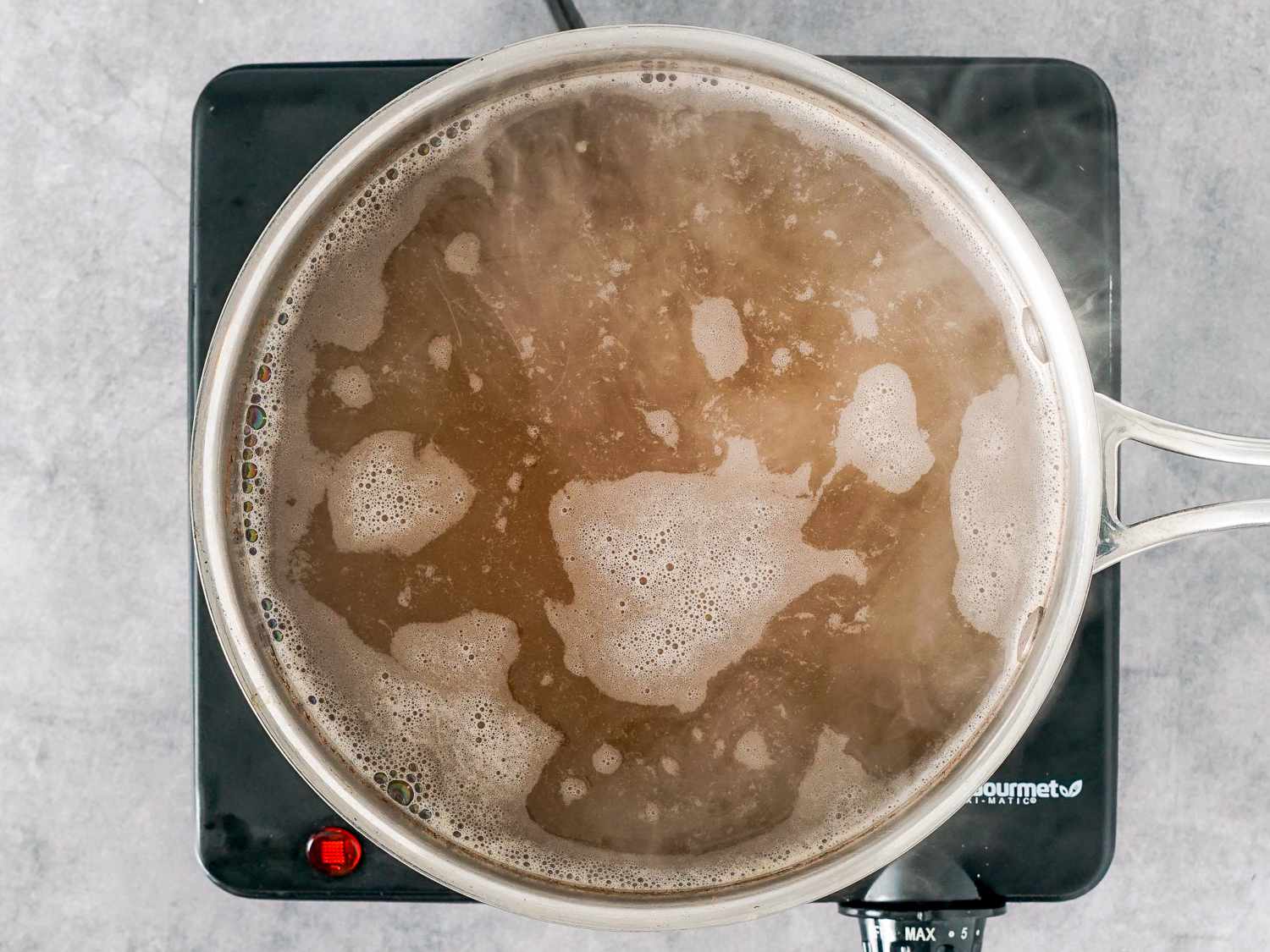 broth and spices simmering in a pot