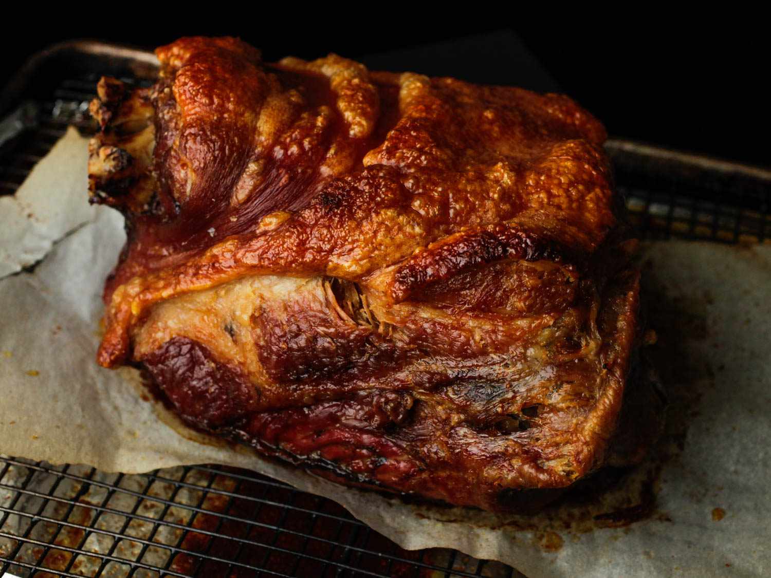 A whole roasted pork shoulder with crispy skin.