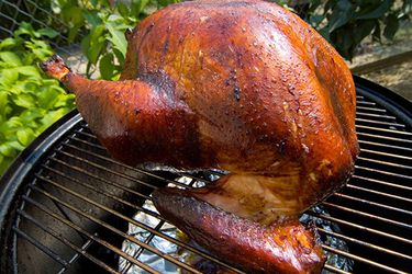 A whole turkey on a grill. 