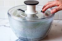 stopping the spinner on the oxo plastic salad spinner