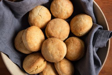 Batch of cream biscuits resting in an earthenware bowl