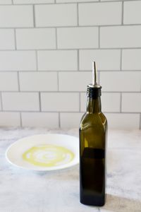 Zulay oil dispenser next to a dish with olive oil