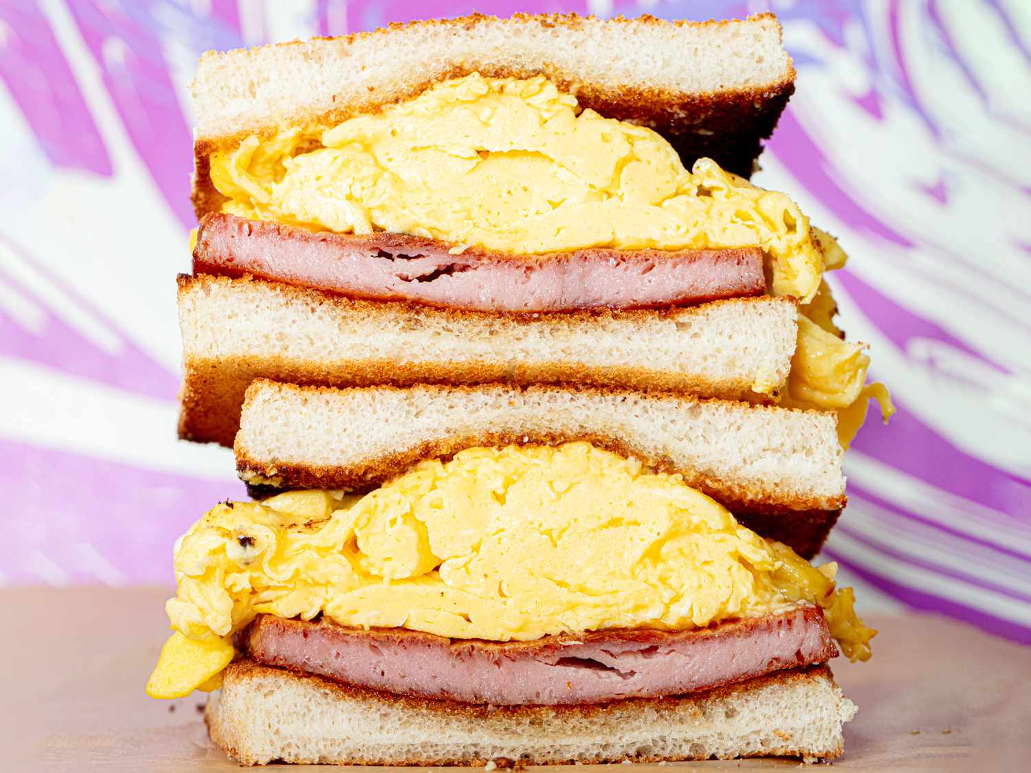 Side view of inside of spam and egg sandwiches stacked