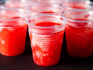 Clear plastic cups filled with chilly bears. 