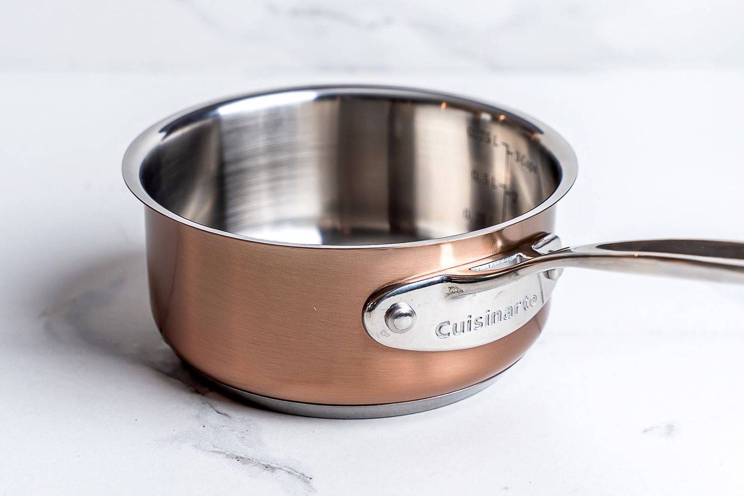 A pot from the Cuisinart Copper Collection Tri-Ply Cookware 8-Piece Set on a white surface