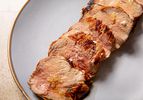 Slices of a grilled pork tenderloin on a plate