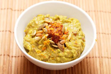 Closeup of Chipotle-Orange Guacamole With Toasted Pumpkin Seeds.