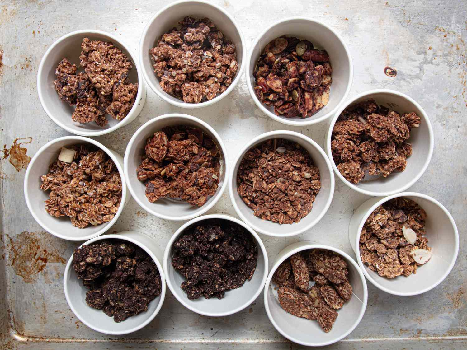 Bowls of chocolate granola arranged in a grid on a table