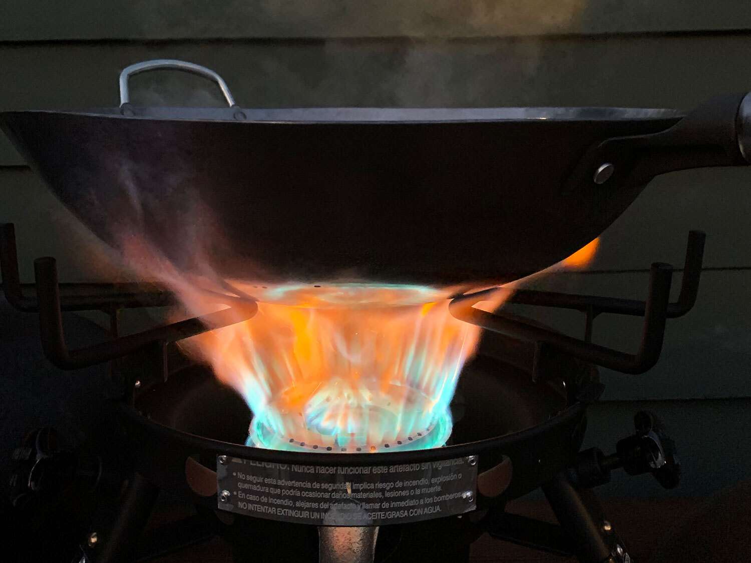 Wok over flames from outdoor wok burner