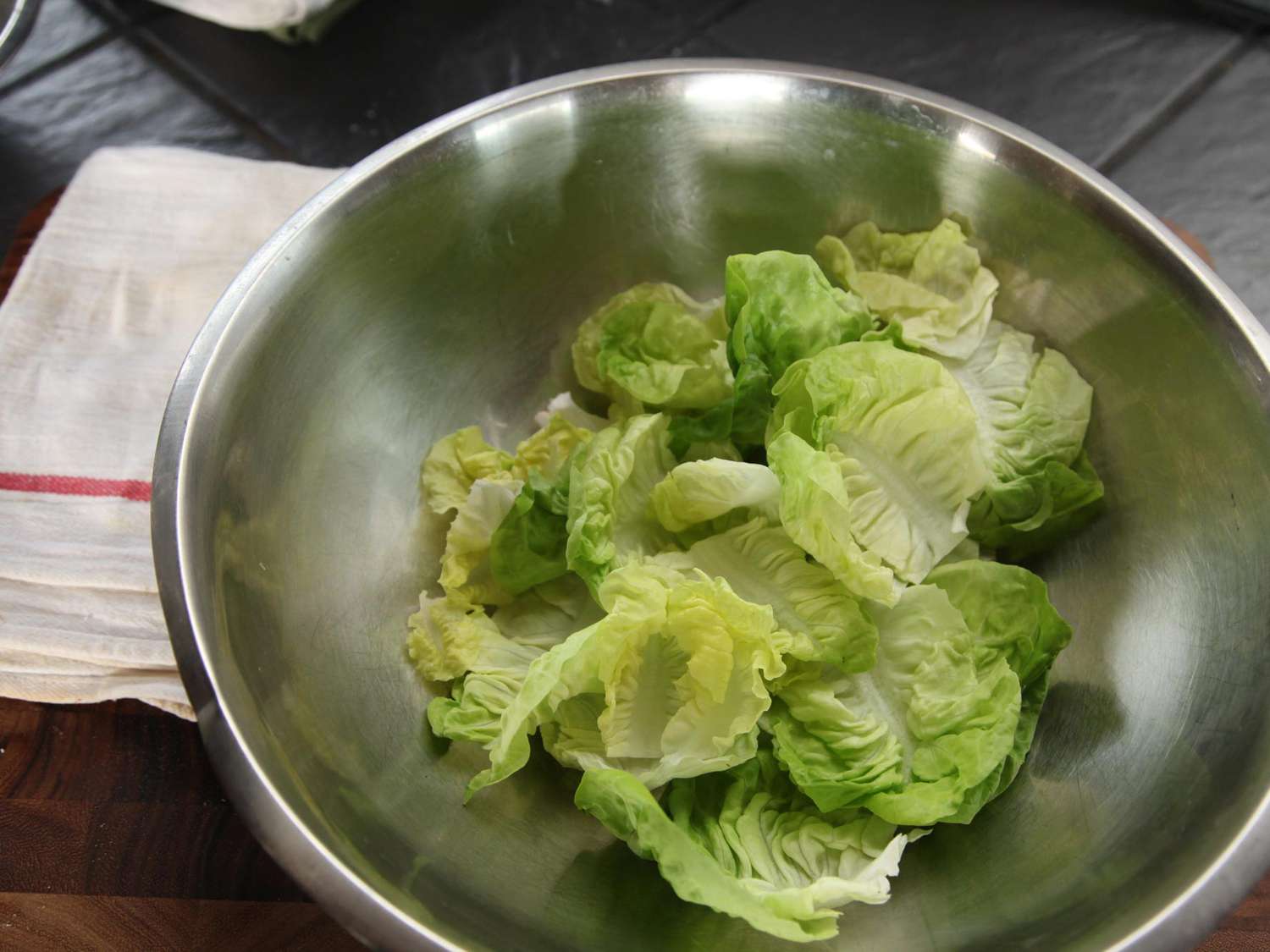 Little gem lettuce leaves in a mixing bowl, ready to be dressed.