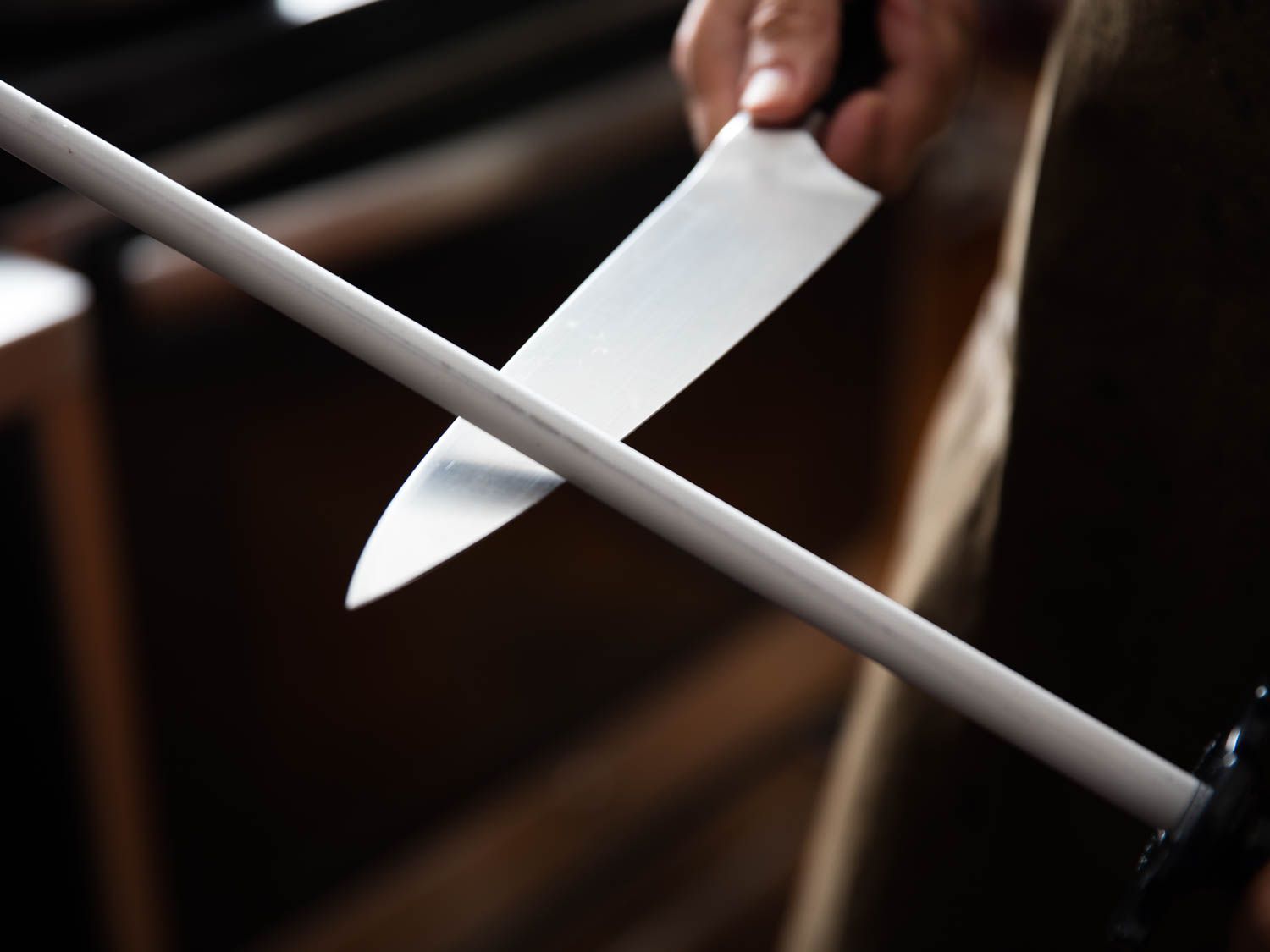 a knife being sharpened with a ceramic honing steel