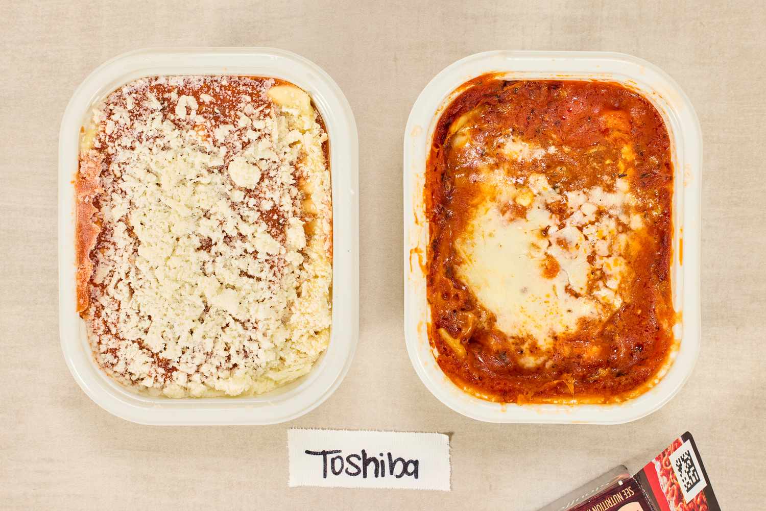 An unheated microwave meal next to a meal cooked in the Toshiba EM131A5C-BS Microwave Oven