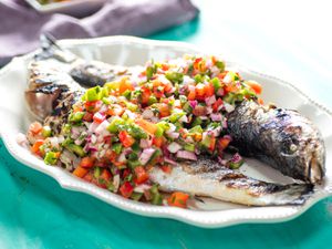 Platter of two whole grilled fish with Brazilian pico de gallo