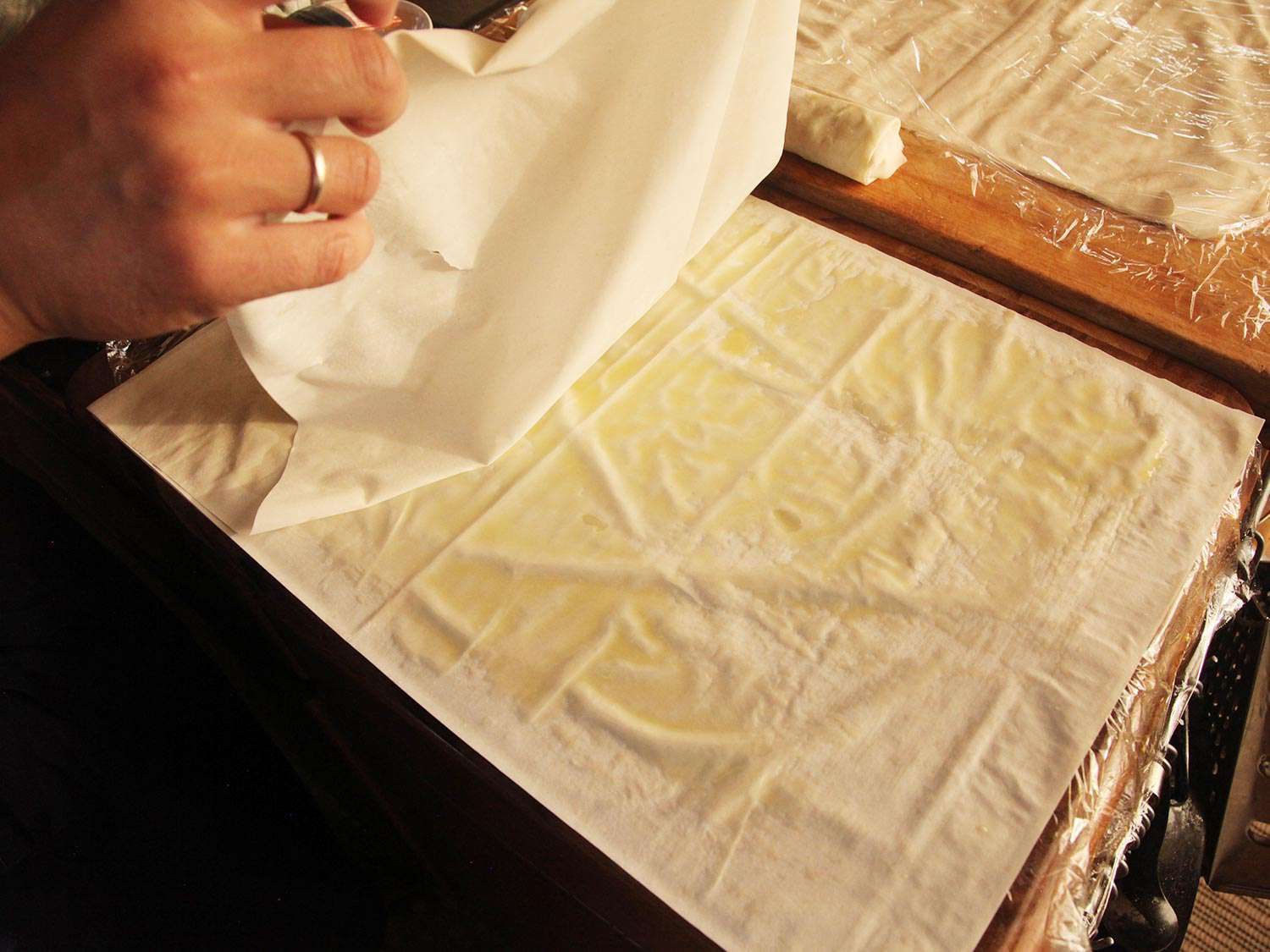 Laying phyllo sheet on top of another olive oil brushed phyllo sheet.