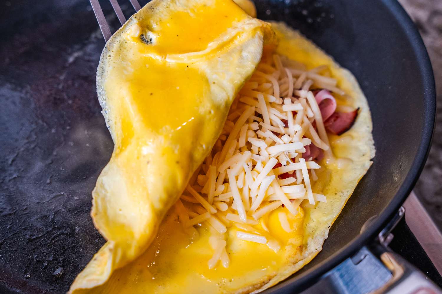 An omelette cooking in the Misen Nonstick Pan