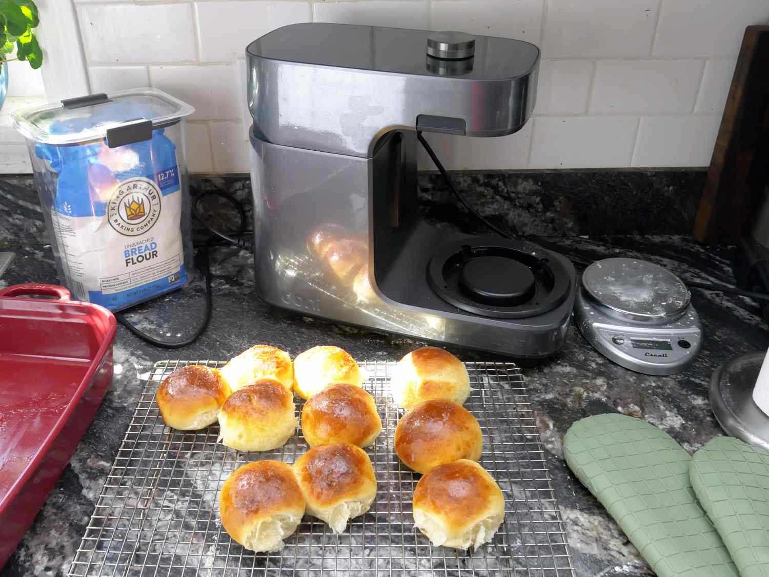 fresh-baked dinner rolls on a cooling tray in front of the ooni stand mixer