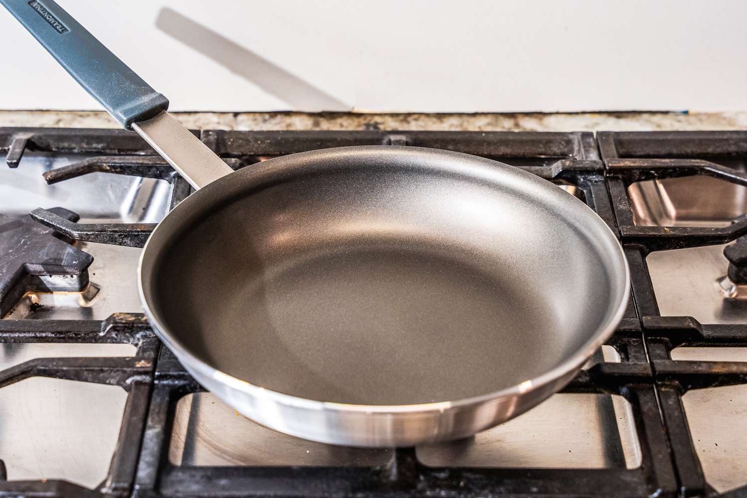 The Tramontina 10-Inch Professional Aluminum Nonstick Restaurant Fry Pan on a stovetop.