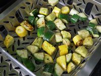 closeup of the proud grill basket with charred summer squash and zucchini