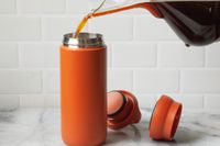 Coffee being poured into the Kinto travel mug.