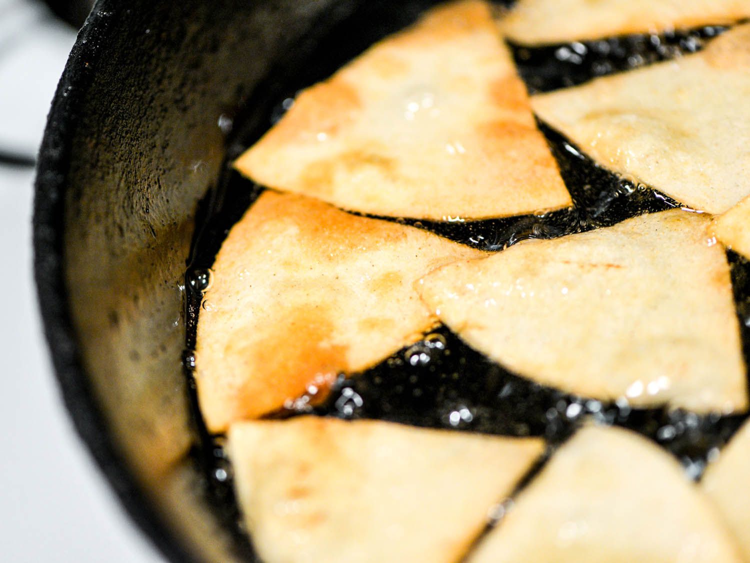 Close-up of tortilla chips frying in oil