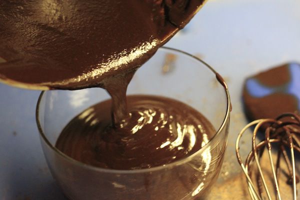 transferring broken ganache into a glass bowl