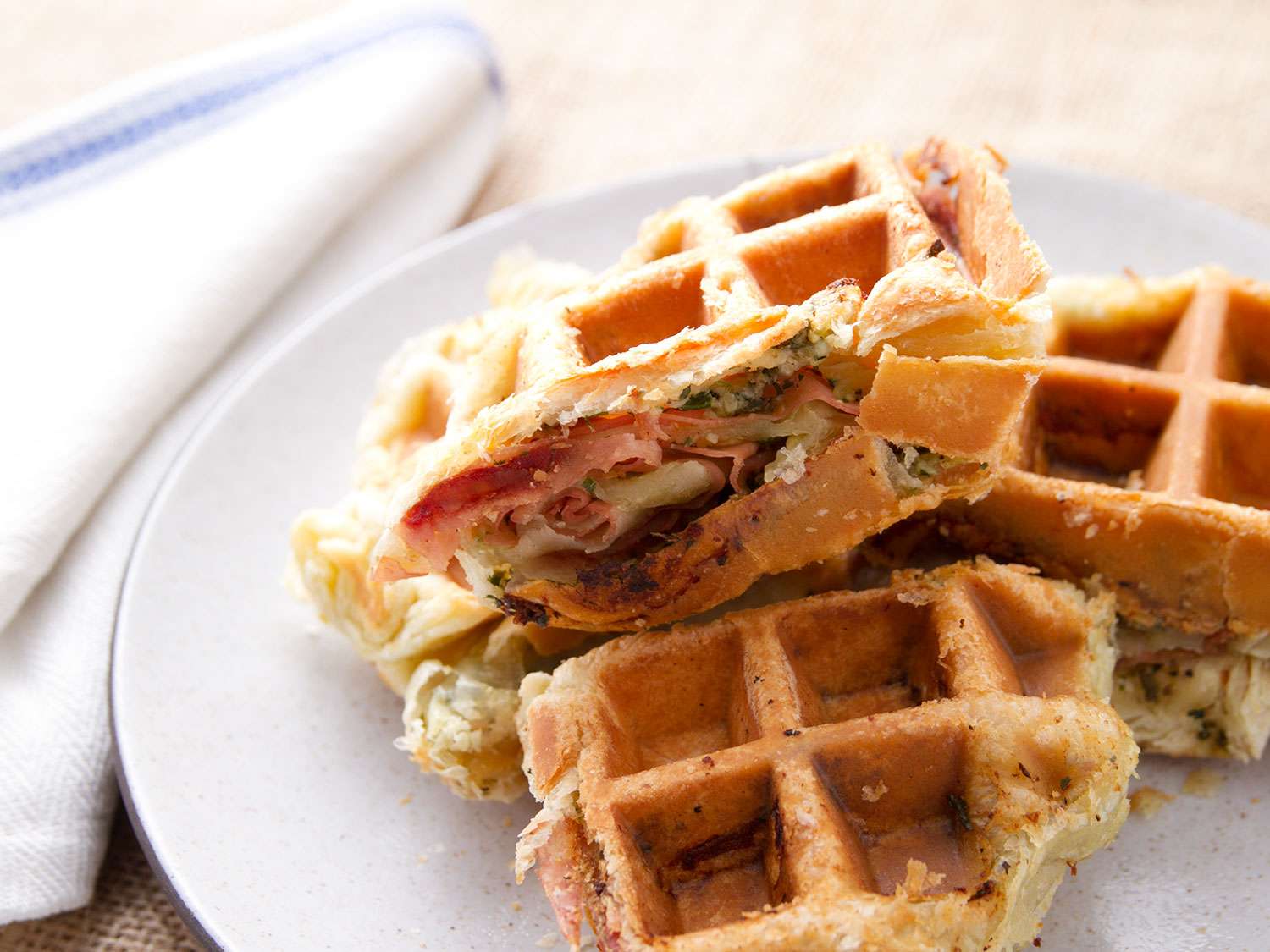 Cross-section pieces of mortadella layered in garlic puff-pastry waffle
