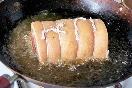 sous-vide cooked pork belly porchetta deep-frying in wok