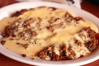 Closeup of choriqueso, served in a shallow bowl.