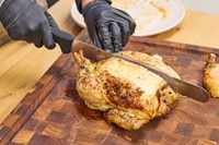 Chicken is cut with the Victorinox Fibrox Pro 12-Inch Slicing Knife with Granton Blade