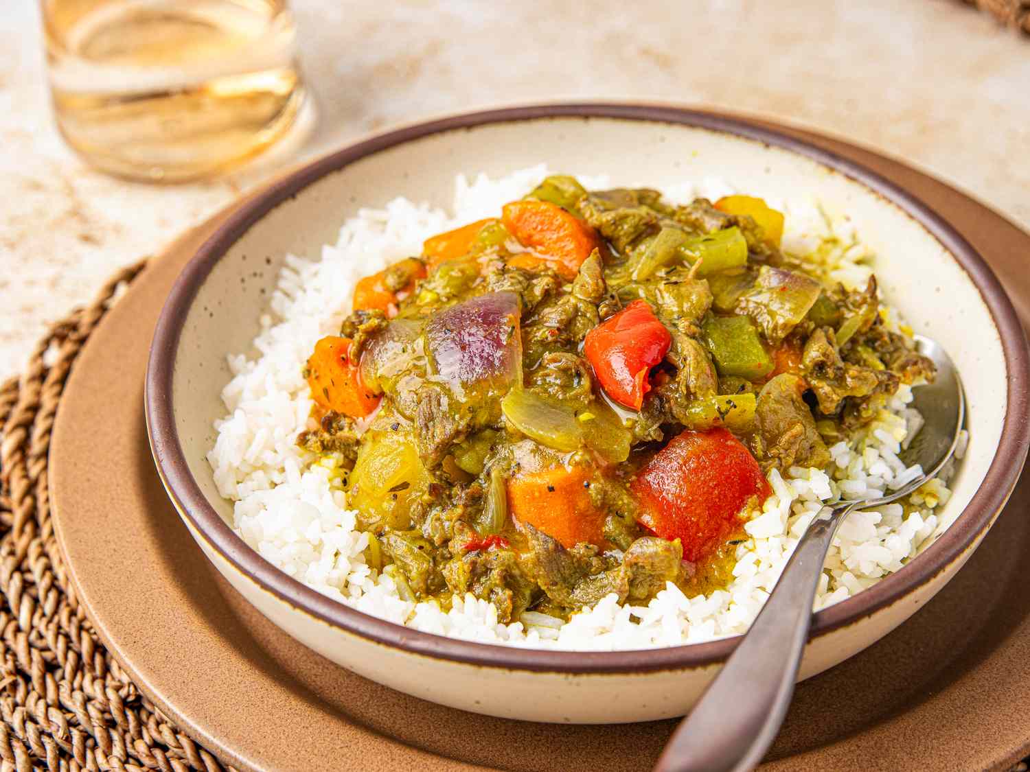 A bowl of Nigerian beef curry served over white rice