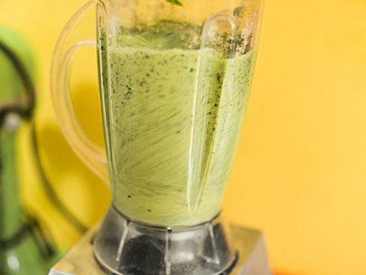 Green mole ingredients are puréed in a blender.
