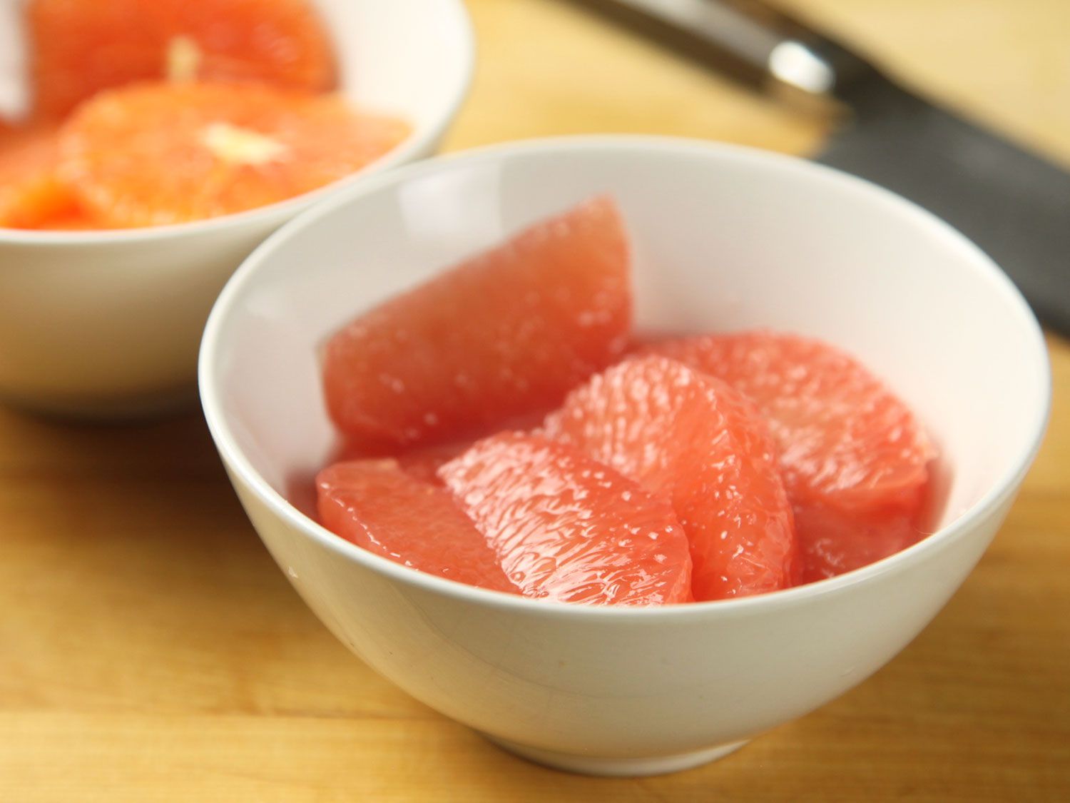 A bowl filled with sectioned and supremed grapefruit wedges for a beet salad.