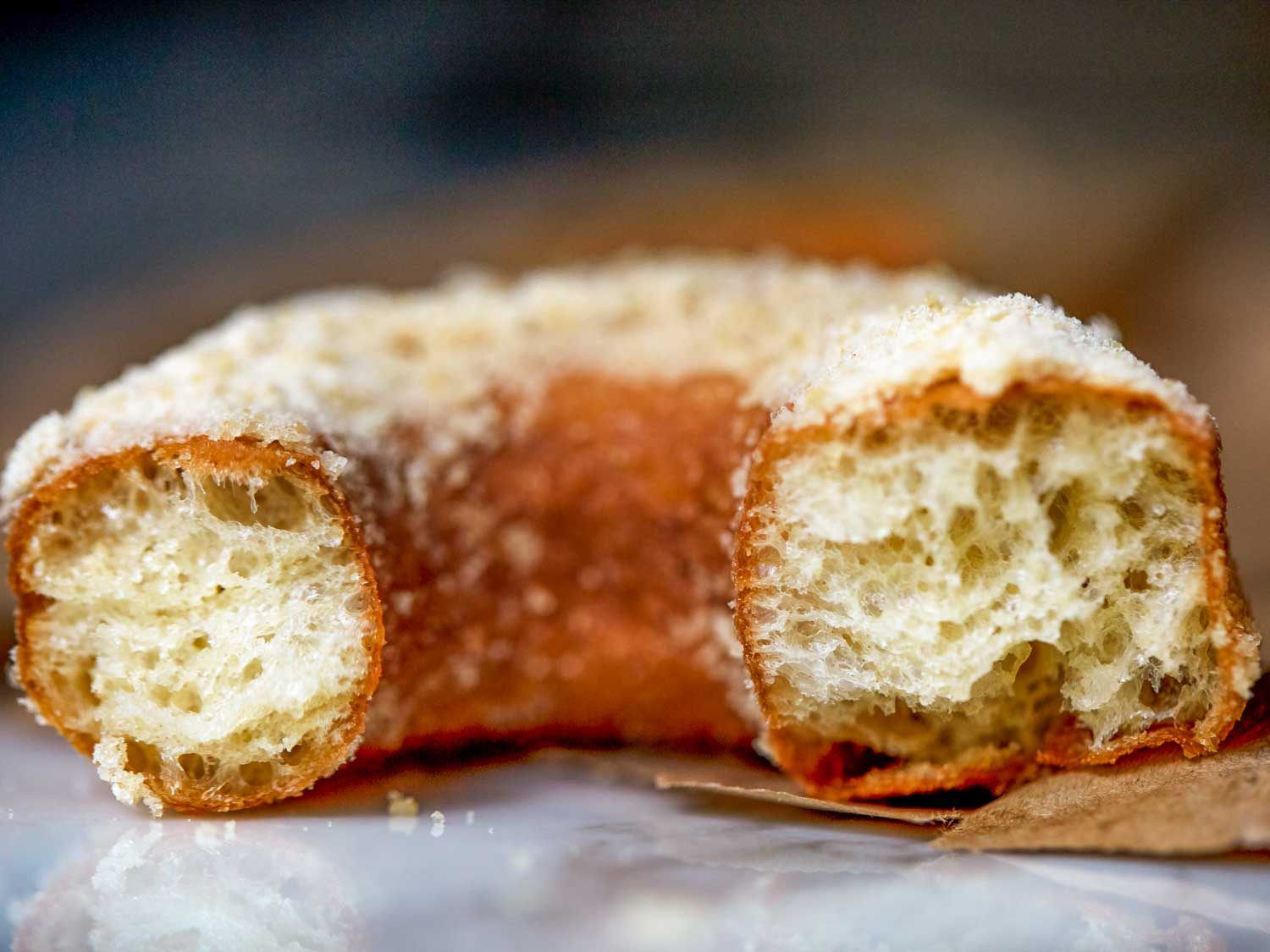 detail shot of an apple cider donut dusted in caramel apple sugar