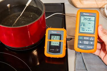 the polder thermometer being used to take the temperature of a pot of boiling water